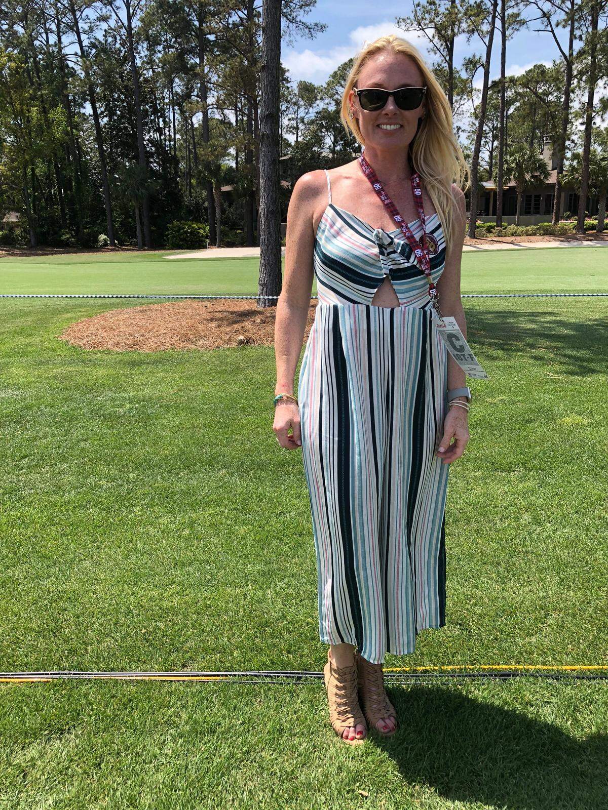 Caroline Walasek wears a striped jumpsuit at the RBC Heritage Golf Tournament on Friday, April 13, 2018.