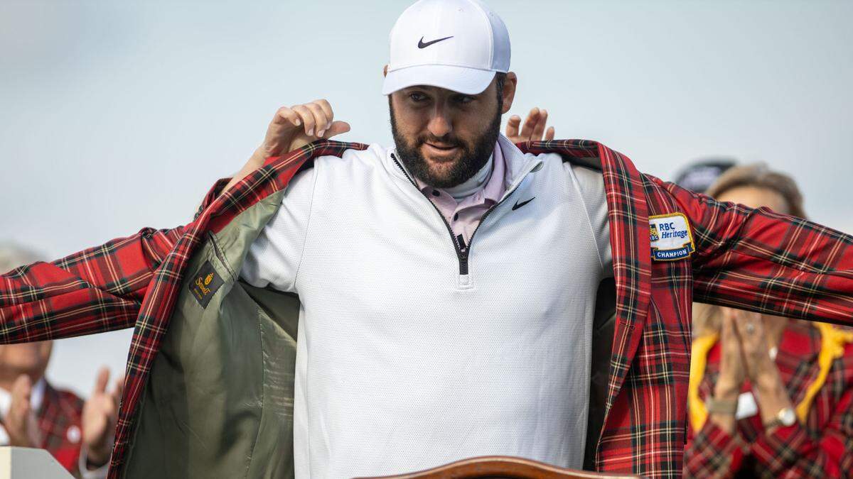 Scottie Scheffler puts on his plaid jacket during the trophy presentation after a rain delay pushed the final round of the RBC Heritage Presented by Boeing at Harbour Town Golf Links to Monday, April 22, 2024 in Sea Pines on Hilton Head Island.