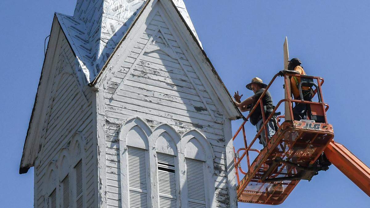 R.J. Arnold, left, and Ervin “Catman” Golden with Savannah-based Metalcrafts, a Tecta America Company, work on April 30, 2025, to repair the 65-foot steeple of the Tabernacle Baptist Church in Historic Downtown Beaufort.