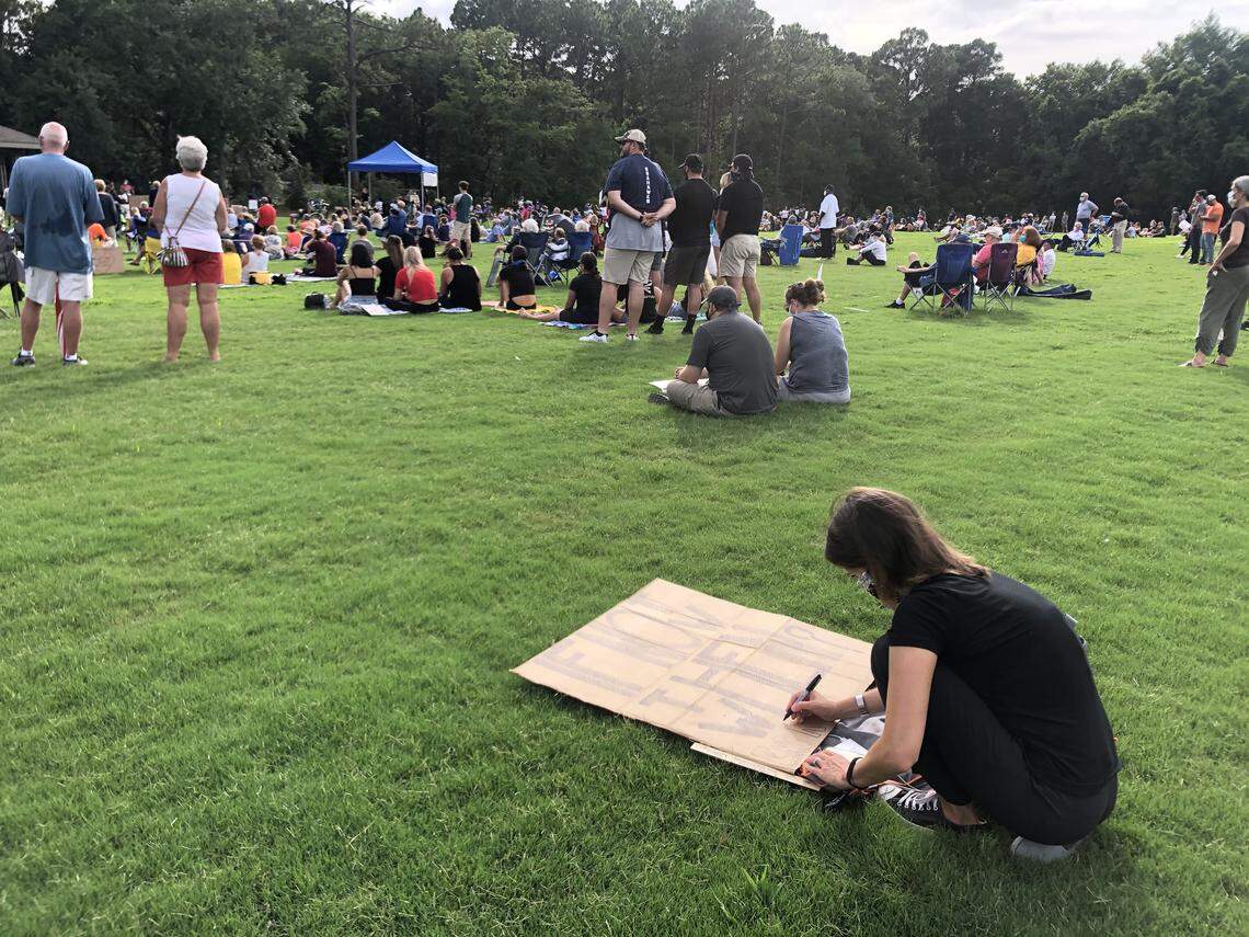 An attendee makes a sign at Chaplin Park on Hilton Head Island Sunday, June 7 and listens to speakers with the Rally for Justice and Change, which was organized to advocate for an end to police brutality and racism. The sign reads “If not now, then when?”