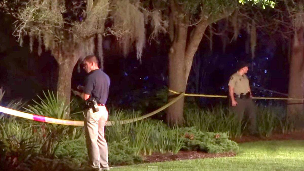 In this still grabbed by a video shot by Hamilton Powell, investigators look for evidence and take photos near the entrance to Coligny Beach on 7/19/2015 in the shooting death of Hilton Head Island 17-year-old Dominique Williams.