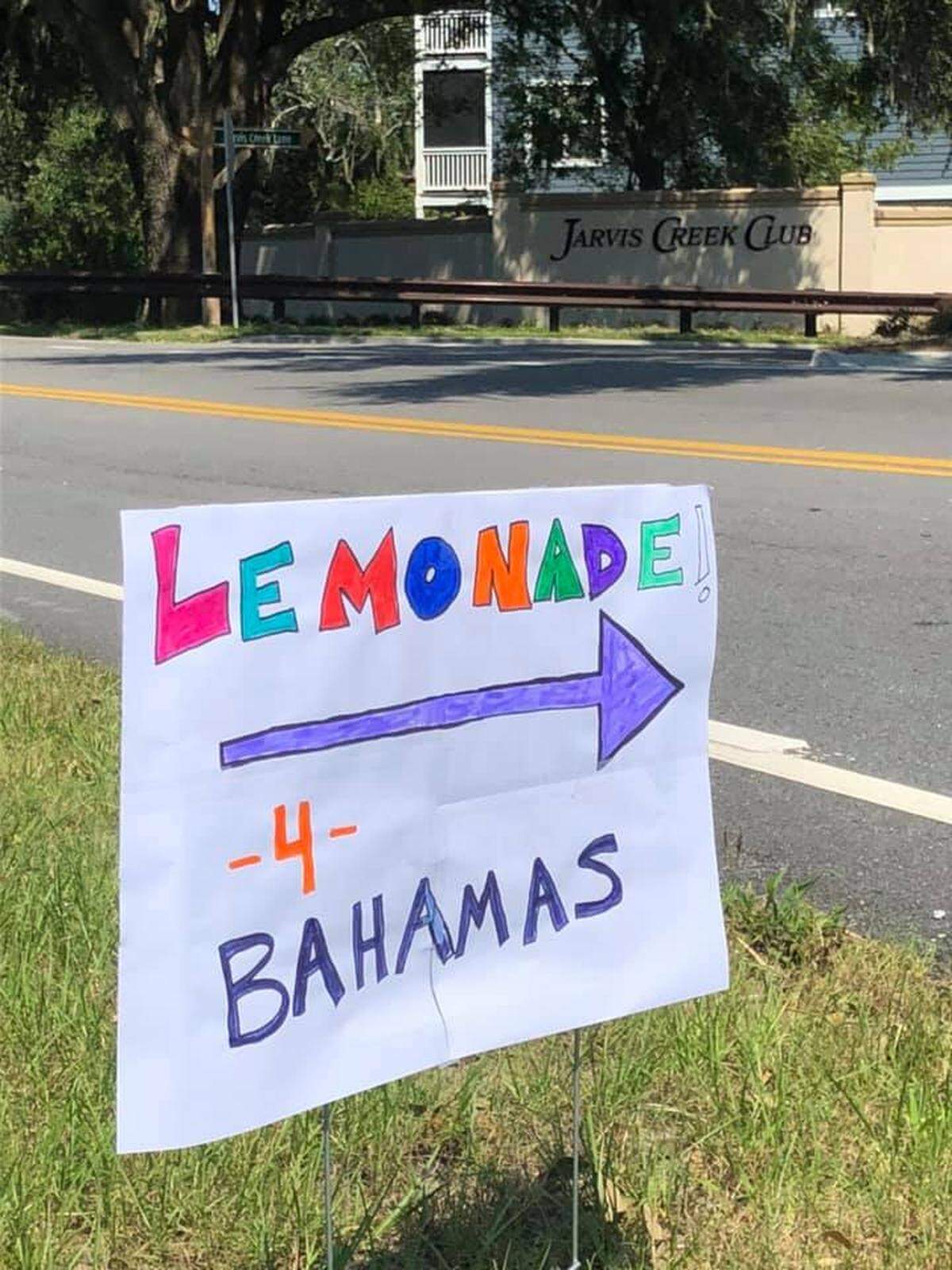 A poster made by a child in the Jarvis Creek neighborhood points to the direction of their lemonade stand that’s raising money for Hurricane Dorian relief efforts in the Bahamas.