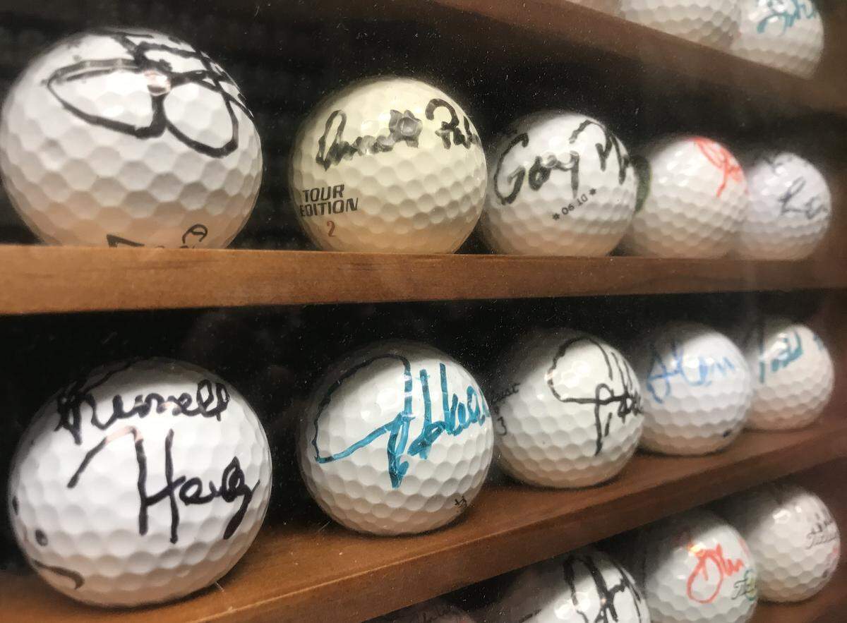 Among the rows of about 15,000 golf balls in Doug Coupe’s attic sits a special glass case full of autographed balls, from golf legends like Arnold Palmer and Gary Player.