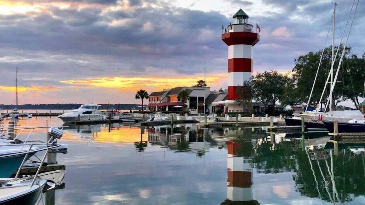 The Harbour Town Lighthouse, marina and Liberty Oak at the 18th green of the Harbour Town Golf Links.