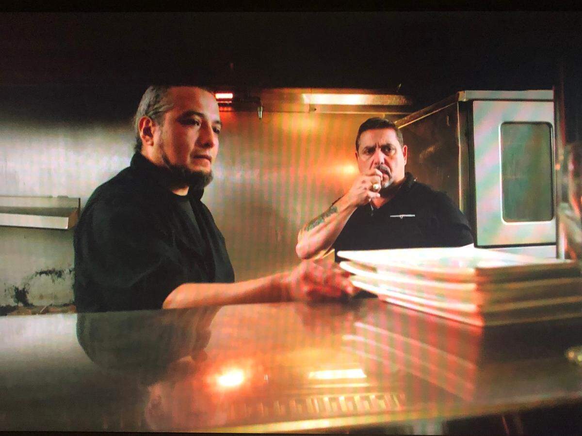 Chef Julio Licona demonstrates the sound of plates rattling in the kitchen at Nonna Lucia restaurant in Bluffton as investigator Steve DiSchiavi looks on.