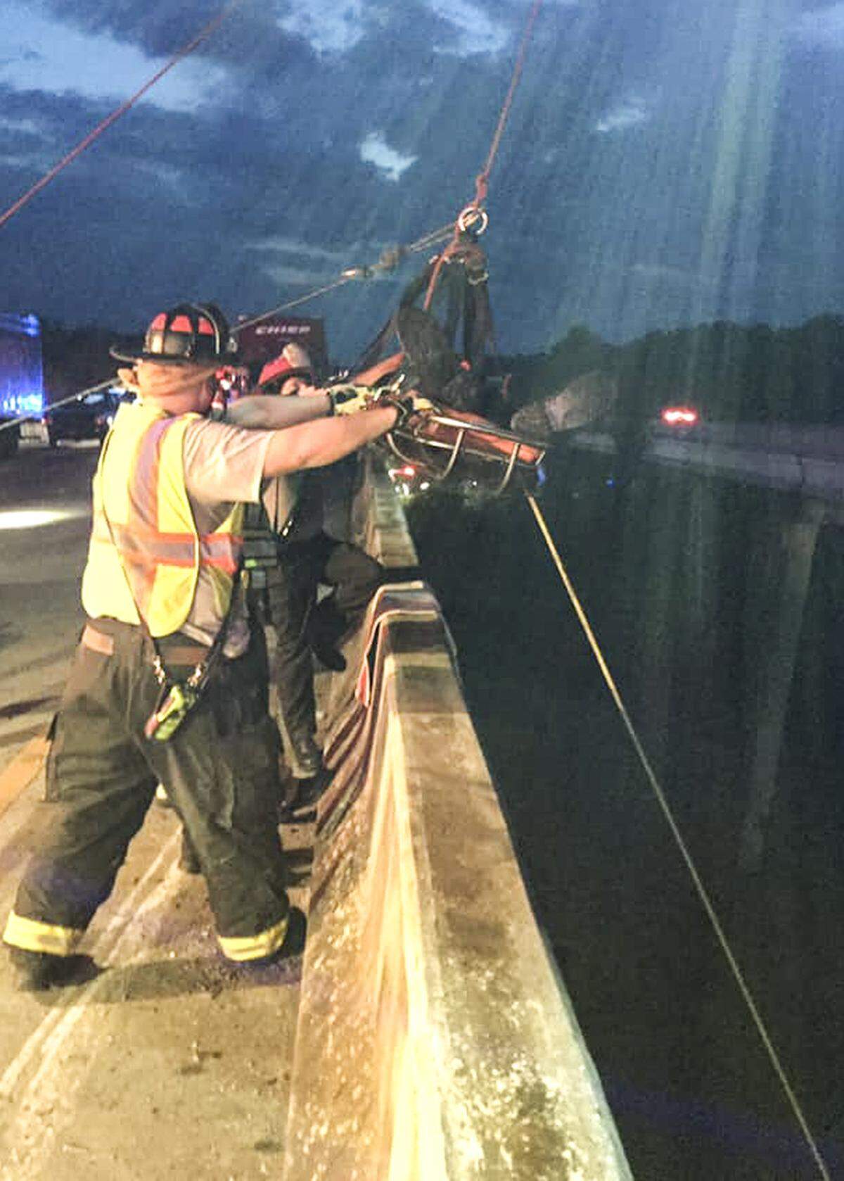 Firefighters from the Hardeeville Professional Firefighters Association lift a driver from beneath an overpass on I-95 near the South Carolina state line Tuesday morning after his truck ran off the road and over the side of the overpass. The driver survived the fall with only “minor injuries.”