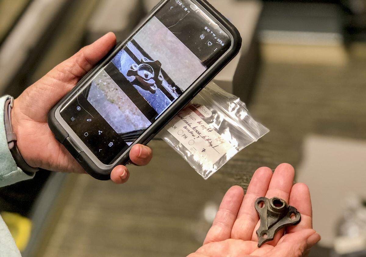 Heyward House Curator Katie Epps compares an artifact discovered on the Wright Family Park Property to a photo.
