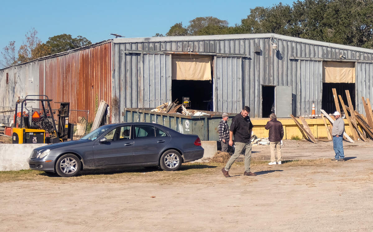 On Dec. 8, 2020, workers stand outside the portion of a building that was at times home to a seafood processing facility associated with the publicly-operated shrimp docks at the end of 11th Street in Port Royal. About 11,000 square feet of the warehouse, near Battery Creek, is slated to house a brewery, restaurant and taproom by Salt Marsh Brewing, part of the redevelopment of the Port of Port Royal.