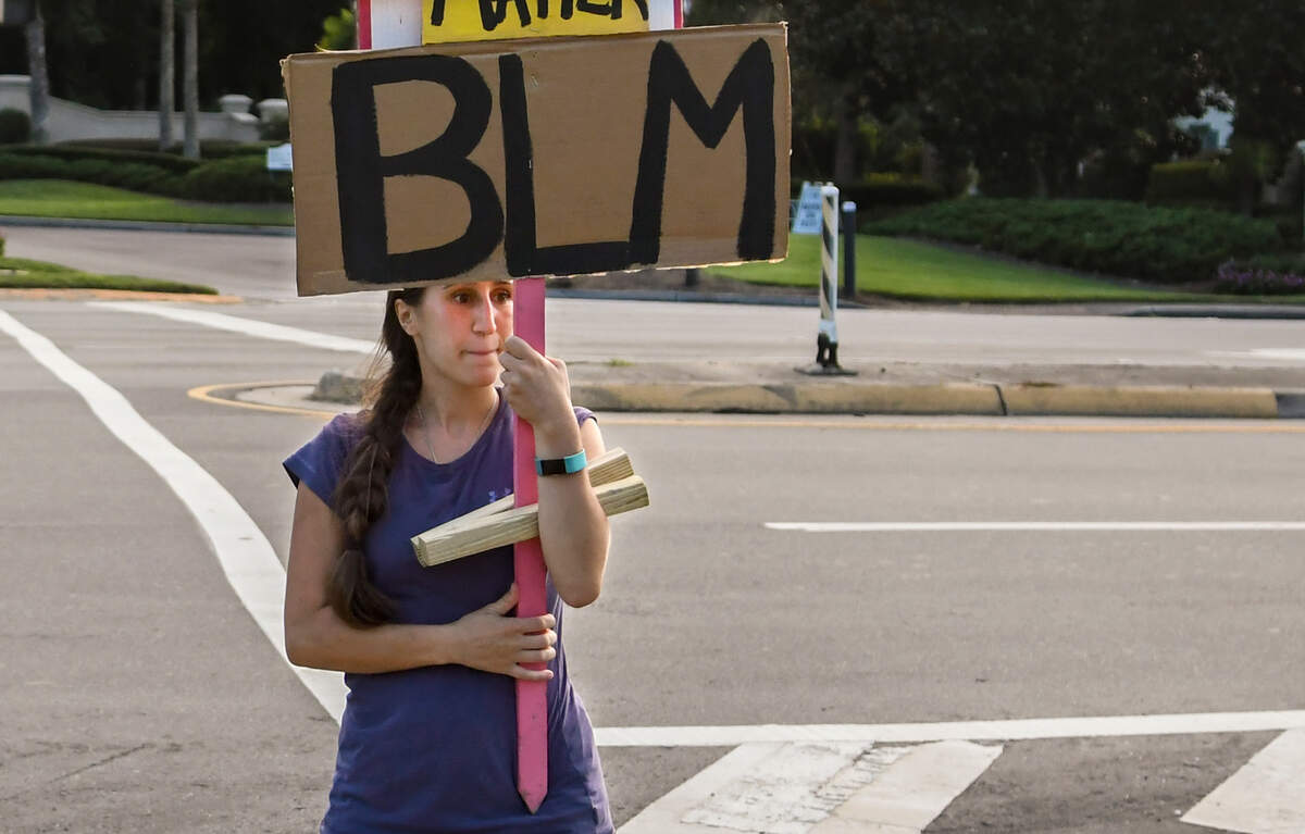 Bluffton resident Chelsea Powell stands at Bluffton and Buckwalter parkways on the evening of Tuesday, Aug. 11, 2020, as she continues the movement to end racism.