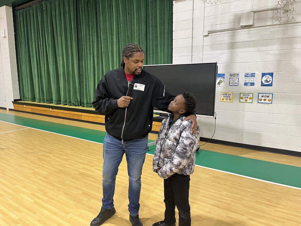 Landau Eugene Murphy Jr., a winner of “America’s Got Talent,” shares a moment with Dovanta Cohen when speaking to St. Helena Elementary students on Friday. He told them, “I want to let you guys know you can be anything you want to be” if they stay in school and apply what they learn.
