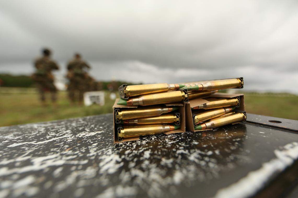 In this file photo, U.S. Marine Corps trainees receive ammunition during a weapons exercise.