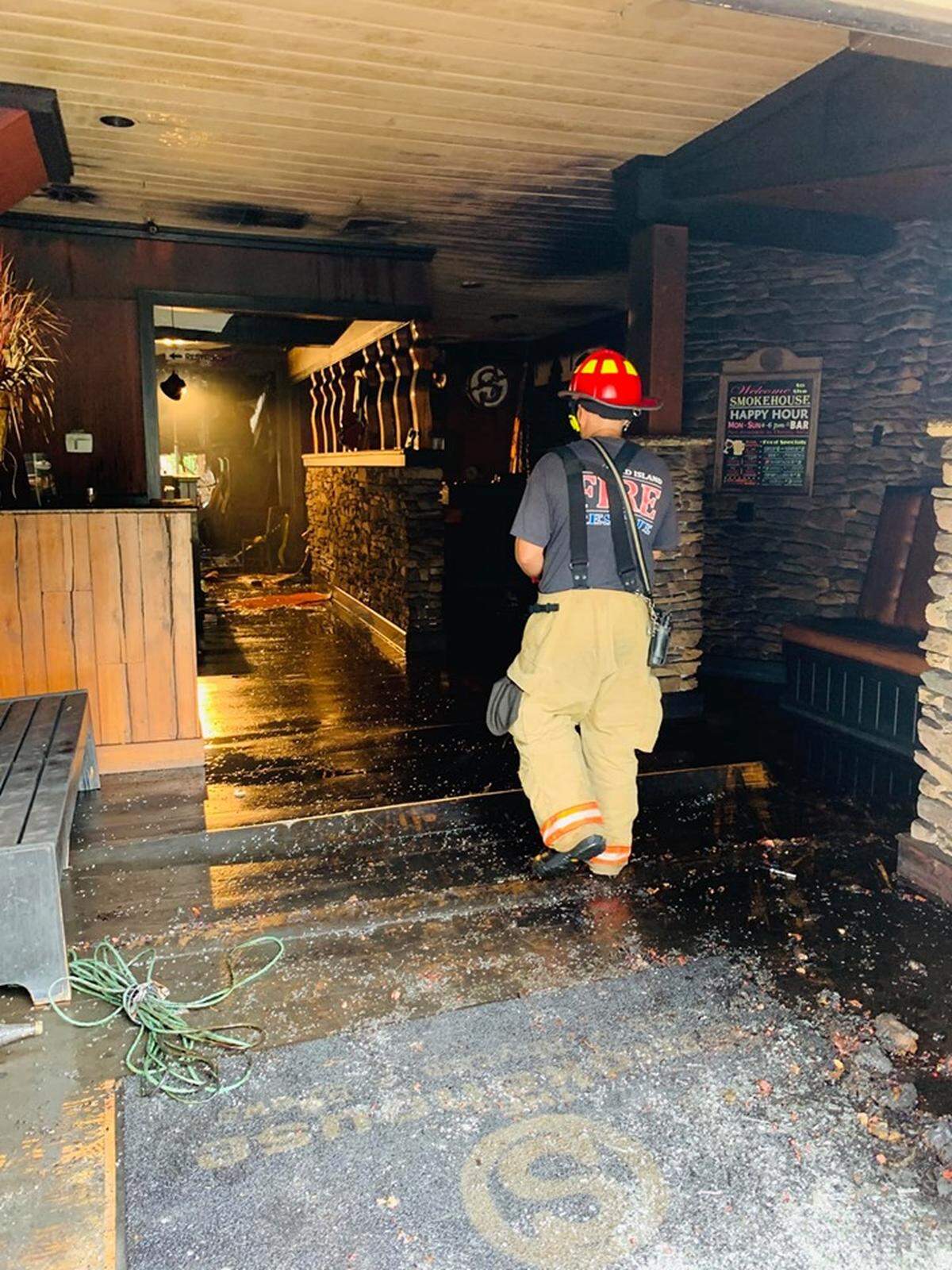 A Hilton Head firefighter surveys damage at The Smokehouse restaurant on Palmetto Bay Road after a fire on Sunday, June 9, 2019.