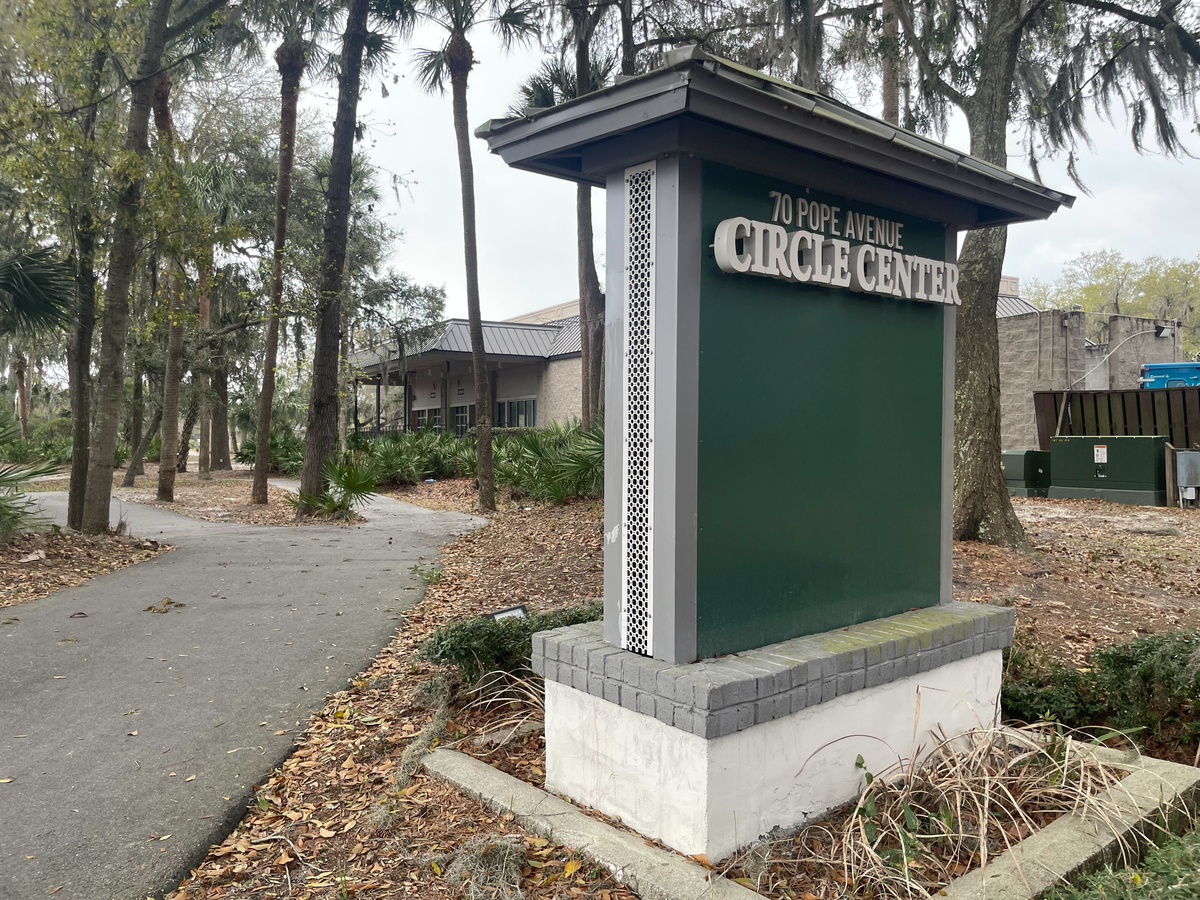 Legal questions, stemming from an agreement between the town and the owners of Circle Center, have complicated plans to develop the $4 million Wild Wing Cafe property into a parking lot or office space.