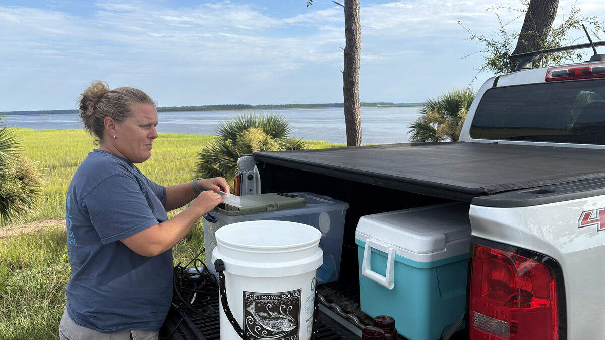 Courtney Kimmel, director of conservation at the Port Royal Sound Foundation, prepares her equipment before taking water quality samples off the shore of Knowles Island. The information she collects will help identify any changes in water quality.
