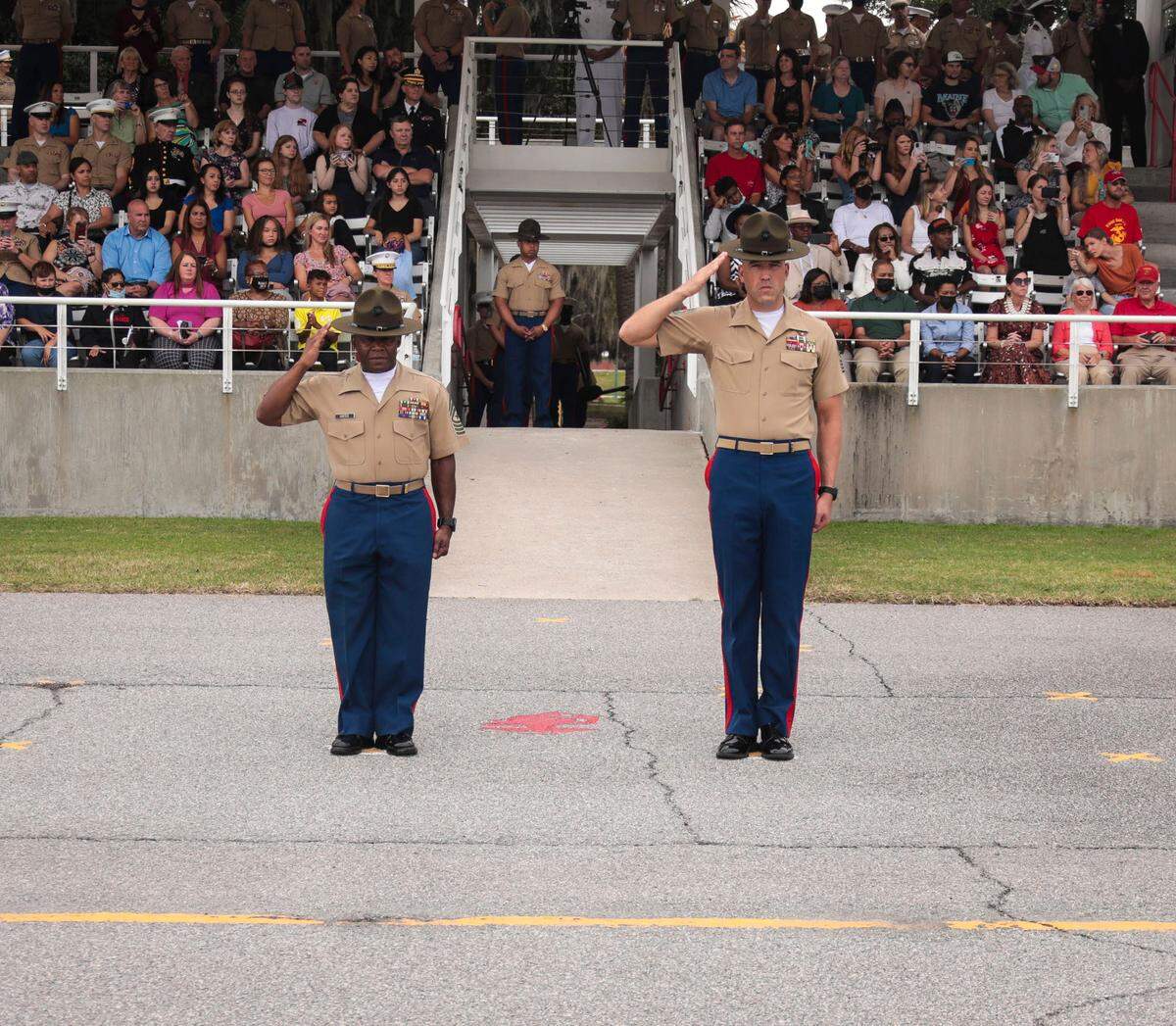 Sgt. Major William Carter, left, salutes recent Marine graduates during a ceremony Friday at Marine Corps Recruit Depot Parris Island. Carter is retiring after 30 years in the Marines, the last two leading recruiting efforts in the Eastern Recruiting Region.