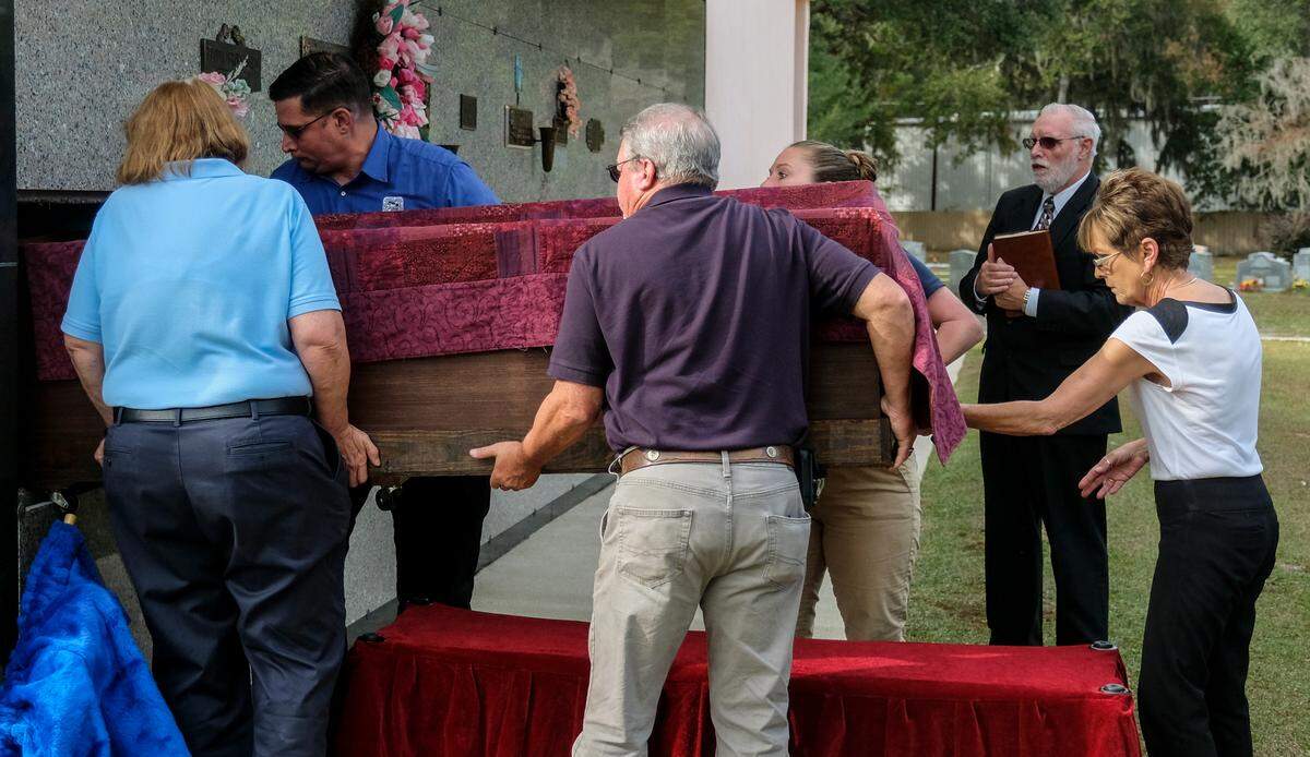 Forest Lawn Cemetery staff help Beaufort County employees inter the cremains of 30 unclaimed persons on Thursday, Nov. 18, 2021 at Forest Lawn Cemetery in Beaufort.