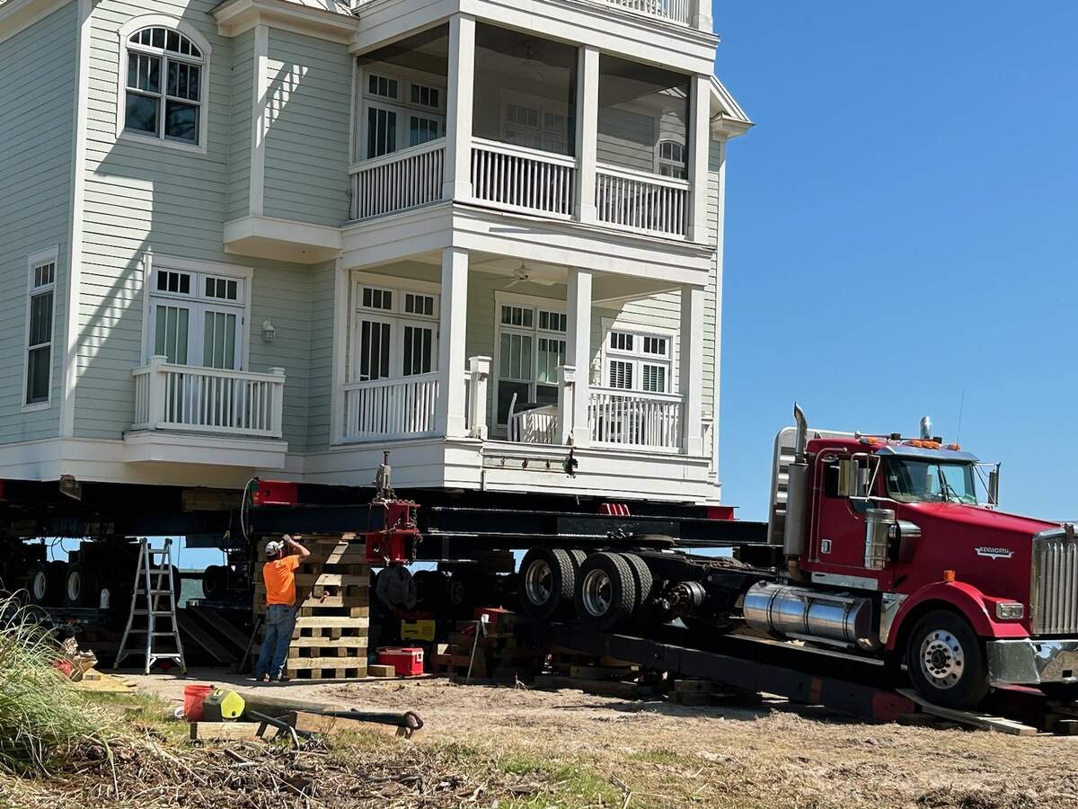 A truck towed the steel and dollys, with the home fitted on top, off the bridge and out of the water.