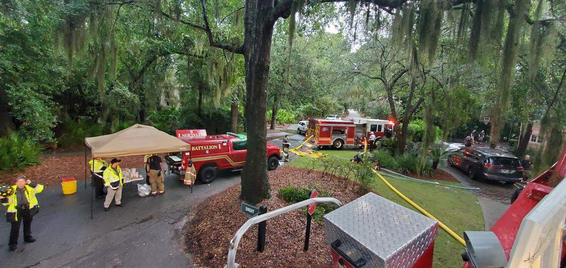 First responders gather on Dinghy Lane on Friday morning in the wake of a deadly house fire.