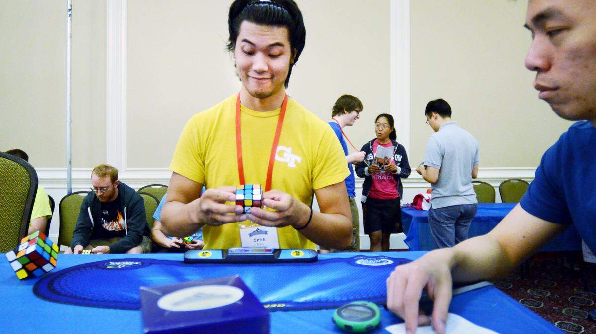 Christopher Tran hastens to solve a Rubik's Cube as Chester Liam judges during at the Rubik's Cube US Nationals 2015 on Thursday at Hilton Head Beach & Tennis Resort. Thursday's preliminary action was a judge's competition featuring tournament organizers and judges. First round competition begins on Friday and continues through Sunday's finals. The United States National Championships dates back to 2004, and has since become the largest competition in the United States with nearly 500 competitors attending in 2014. The competition attracts the fastest American speedcubers, as they are called, as well as top international players. National and world records in cube solving are set every year.