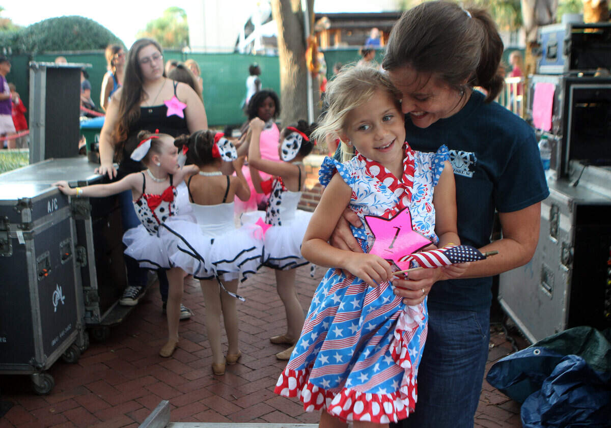 Amy Wilson hugs her daughter Belle, 6, while waiting backstage before for her to sing “God Bless The U.S.A.,” during the Talent Show the 60th Annual Beaufort Water Festival at Henry C. Chambers Waterfront Park in Beaufort. This year’s talent show is Wednesday.