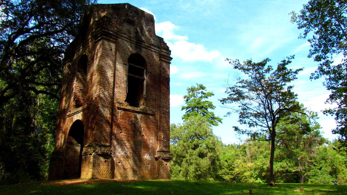 The old church tower at Colonial Dorchester stands alone among a few shattered gravestones. This landmark ,scarred by war, hurricane and even earthquake, was once the center of a thriving colony. 