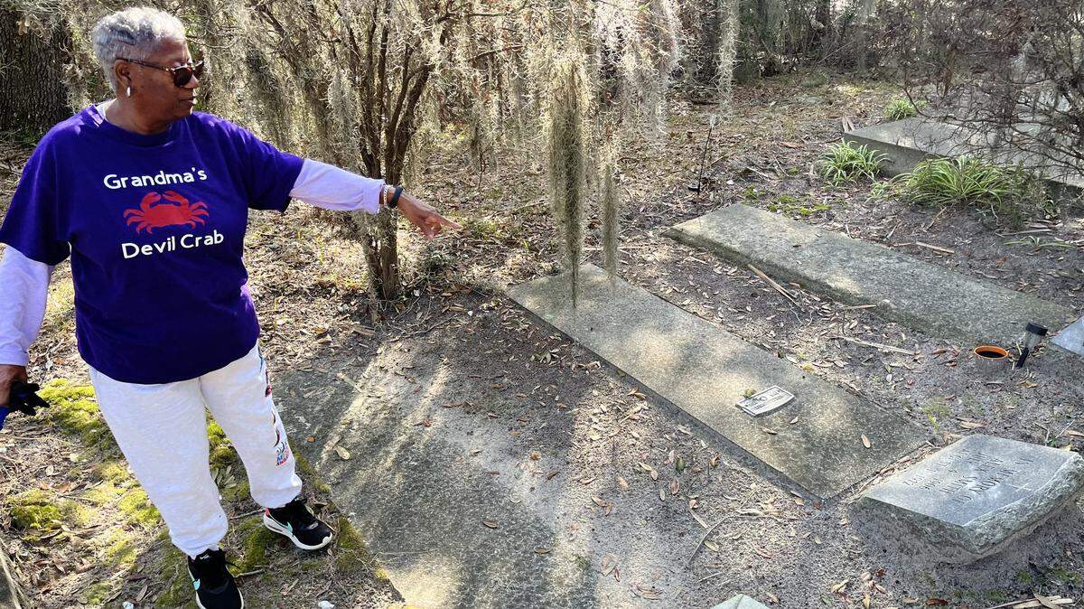 Annie Mae Miller Grant points to the graves of family members at the historic Jenkins Island Cemetery on Hilton Head Island during a community service clean-up day there on Feb. 10, 2024.