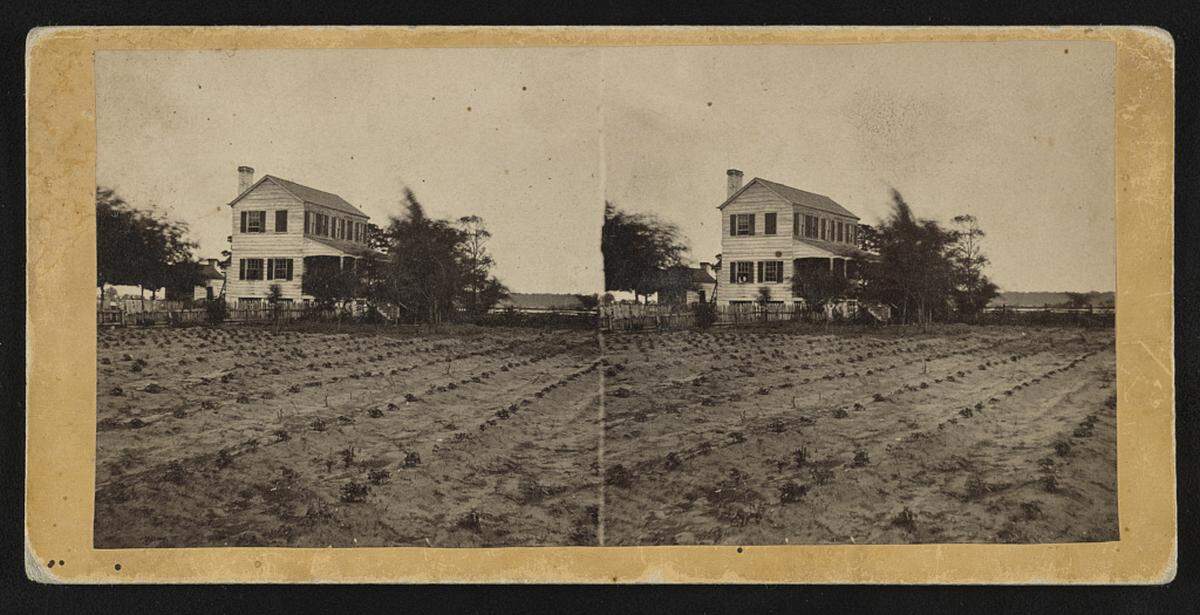 A plantation home sits on farmland near Beaufort, SC between 1862 and 1864.