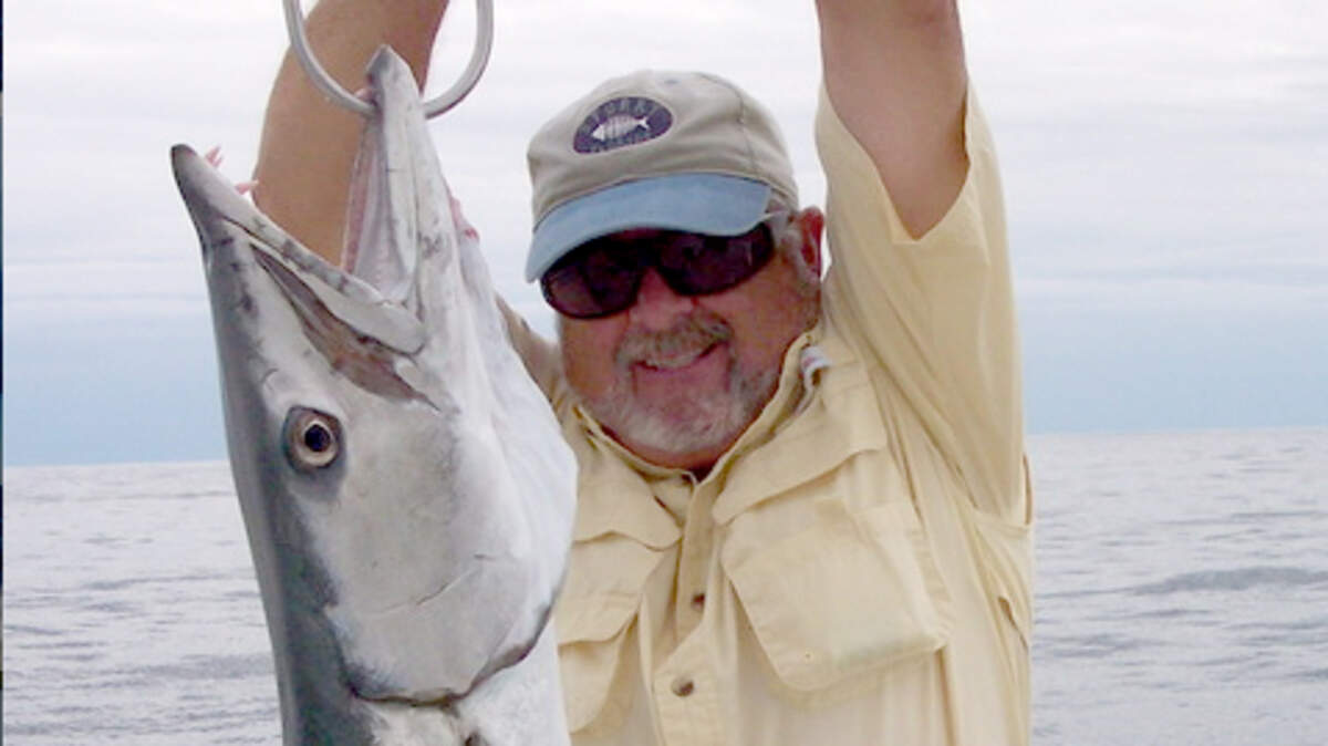 Captain Bill Parker raises a barracuda aboard the Runaway, the charter fishing boat he operated for 32 years from Hilton Head Island, S.C.