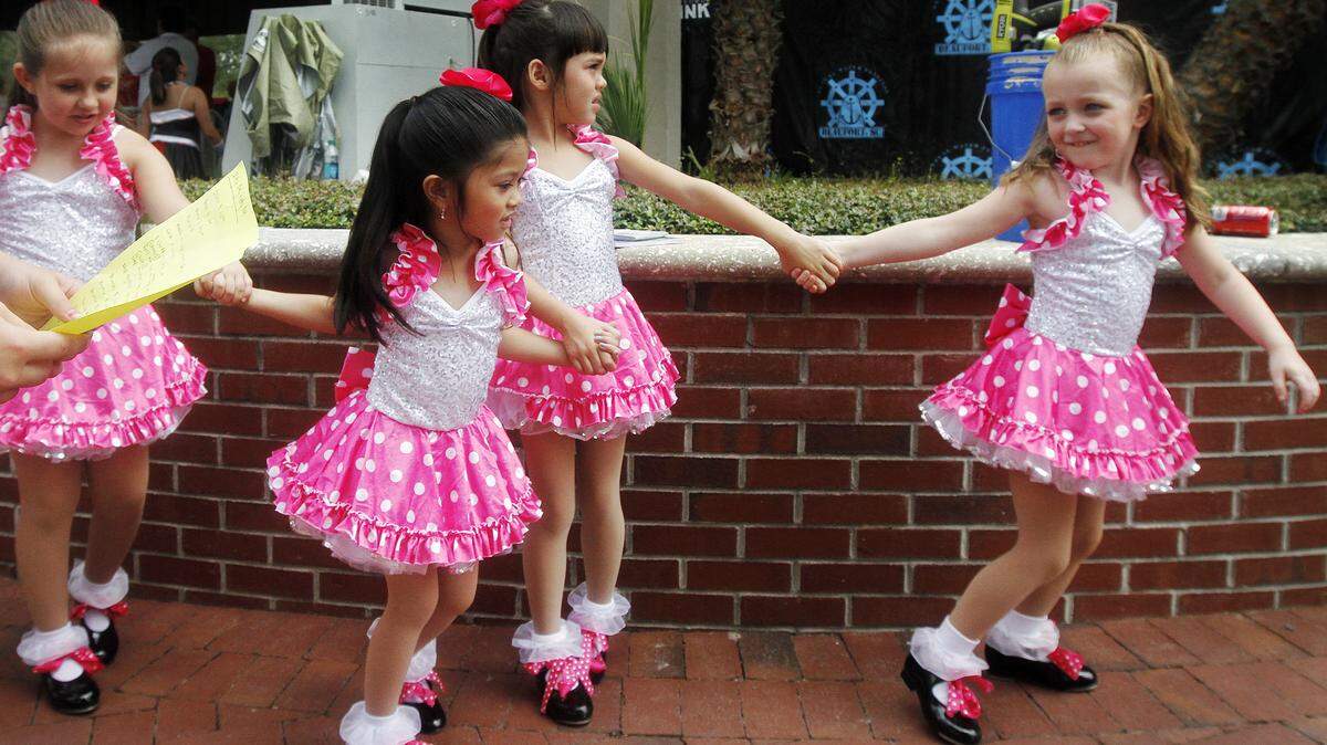 Students with the Beaufort Academy of Dance walk on stage Sunday before a performance during Children's Day at the Beaufort Water Festival at Henry C. Chambers Waterfront Park.