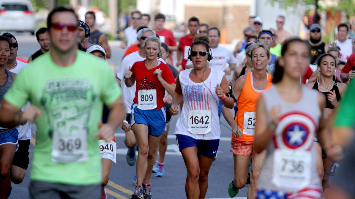 Runners particpating in the 30th Annual Firecracker 5K Run and Walk run along Shelter Cove Lane on Saturday morning on Hilton Head Island.