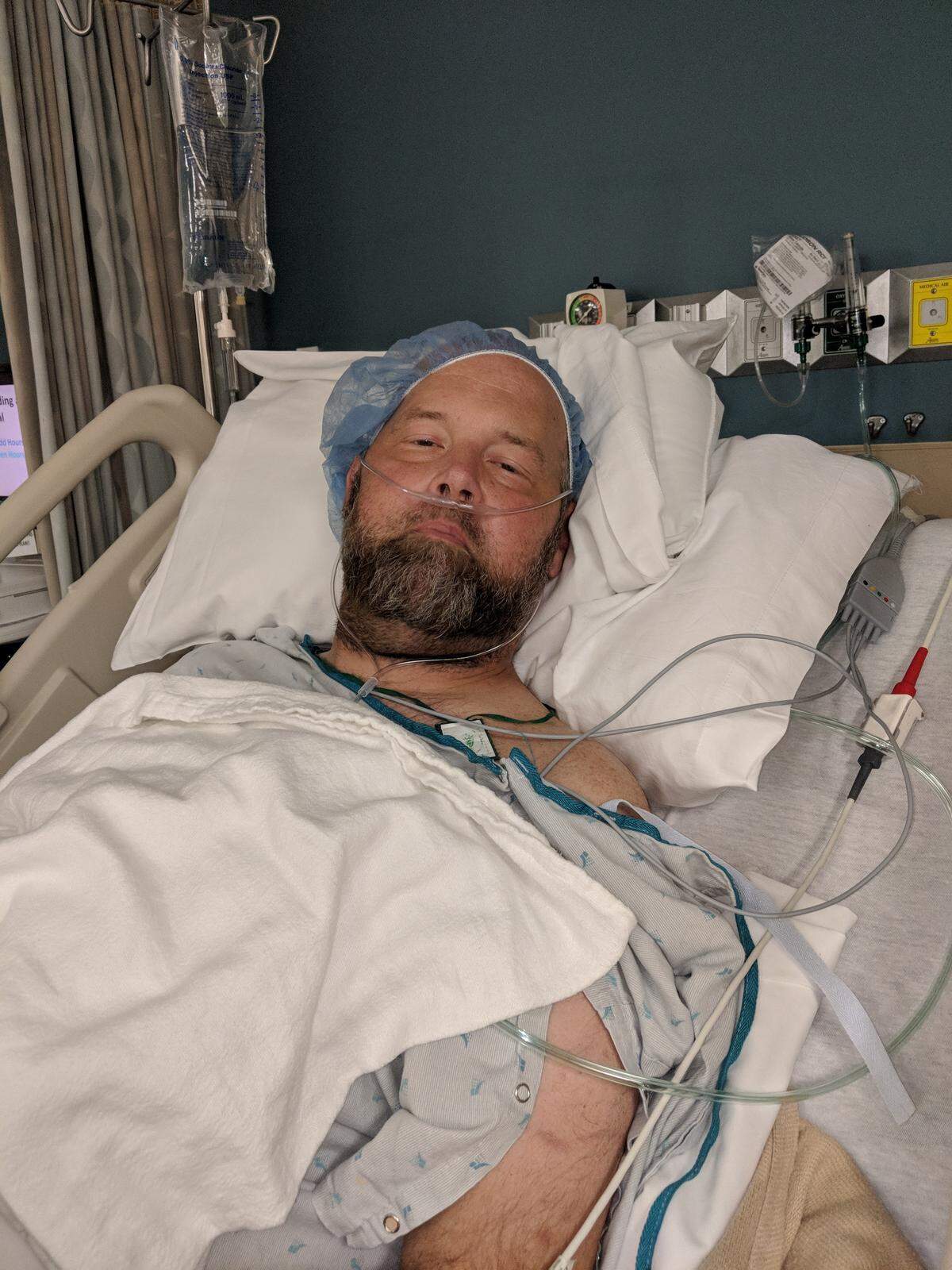 Dave Albany rests in a hospital bed.