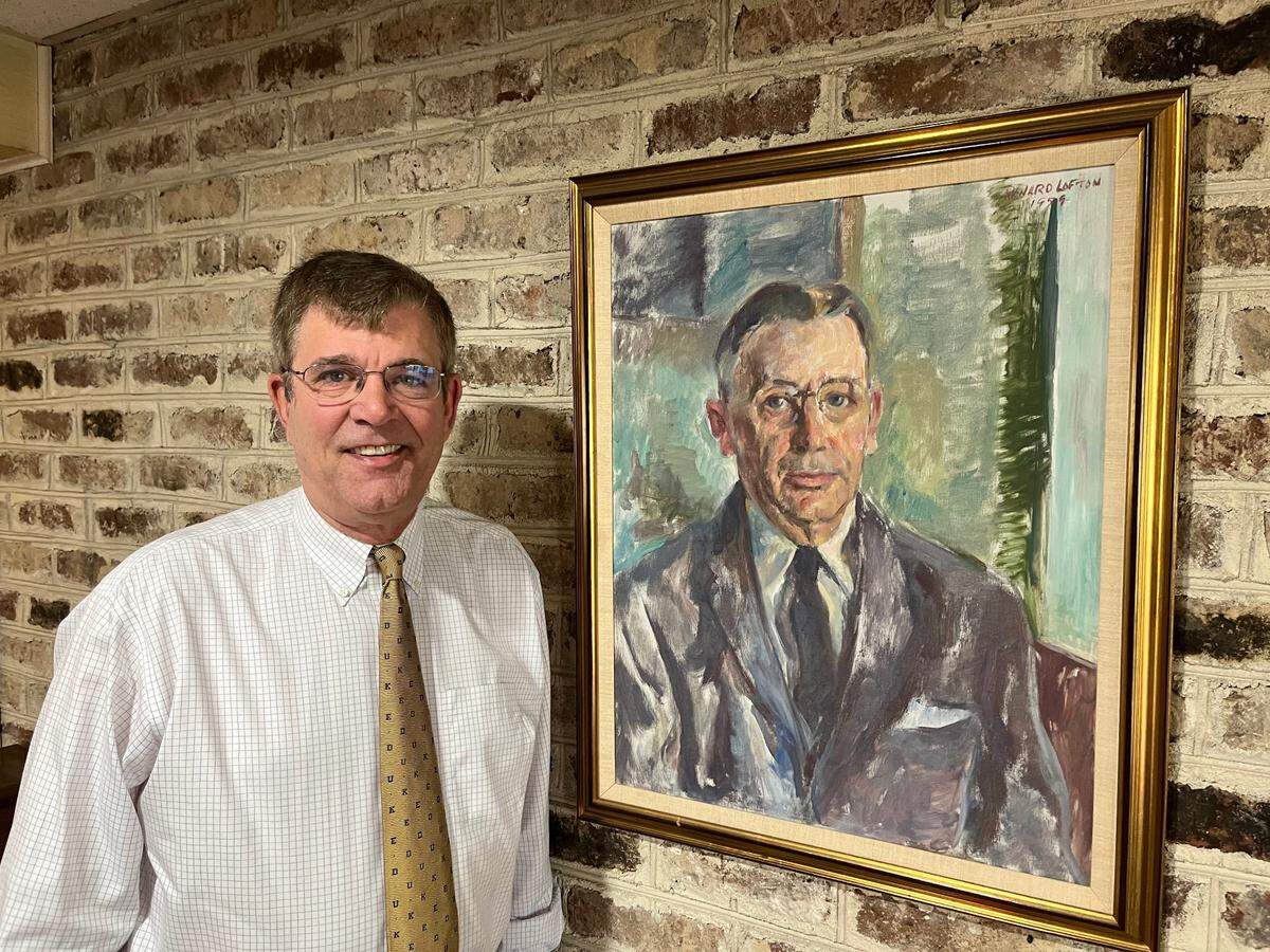 Bill Harvey III stands next to a painting of his grandfather, W. Brantley Harvey Sr., who founded the Harvey and Battey law firm in Beaufort in 1922, at the firm’s offices on Craven Street. The firm turns 100 this month. “It’s a big deal,” Harvey says of the milestone.