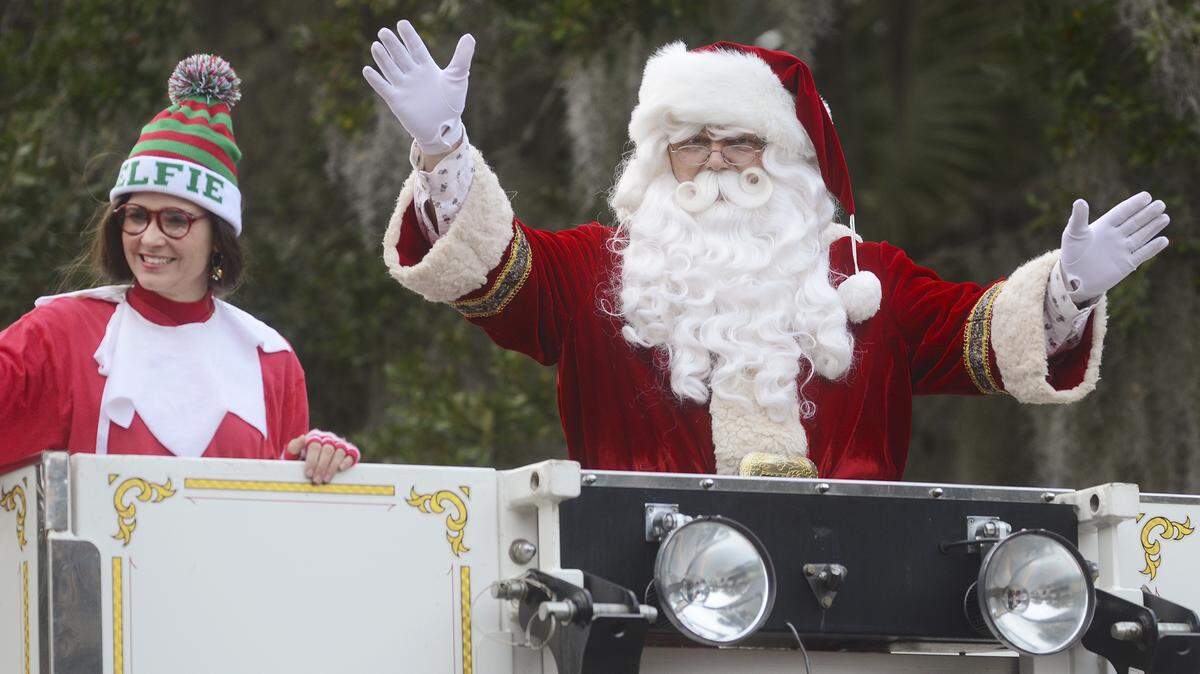 Santa waves to the crowd from a fire truck as the Beaufort Christmas Parade passed down Boundary Street on Sunday.