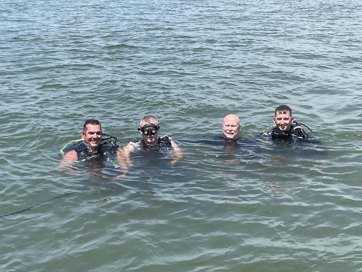 The South Carolina Department of Natural Resources Quatic and Investigations Team works on an experimental coastal protection project this week near Parris Island. From left to right: Willis Bowers, Matthew Owens, Tom Mullikin and Ethan Adair.