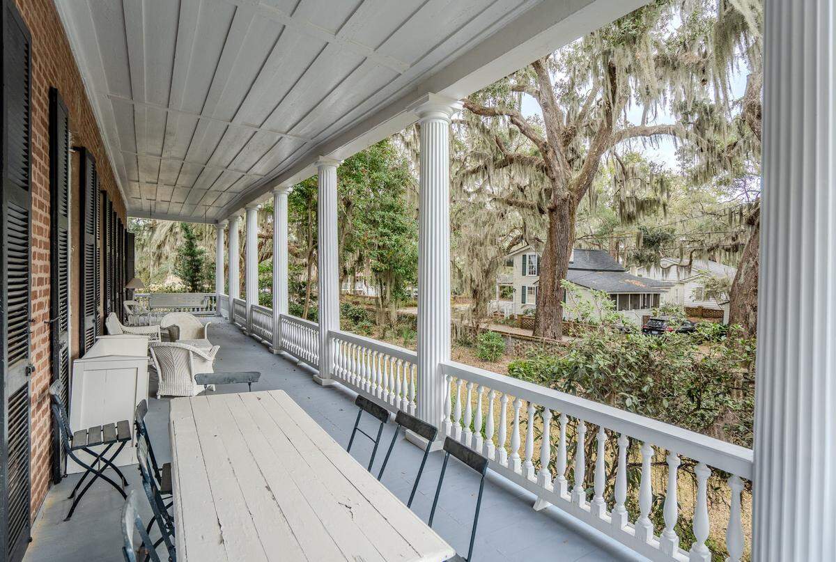 South-facing double porches also function as outdoor living spaces throughout the year, designed to capture cooling summer breezes and warm sunlight year-round.