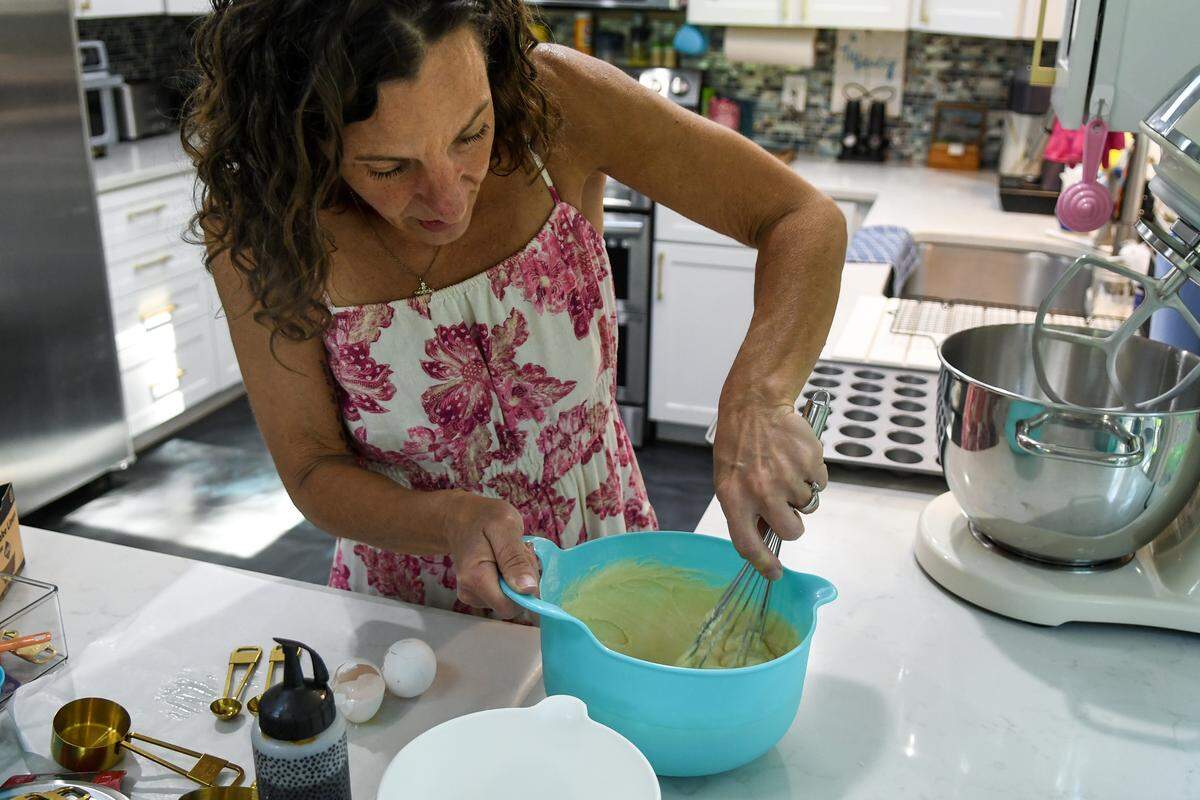 Nicole Lust, owner of Petite Sweets, whisks together ingredients to make vanilla miniature cupcakes on Aug. 26, 2025, at her Hilton Head Island home. Lust decided to make small, bite-size cupcakes after attending a family gathering where the cupcakes served were large, unmanageable and, she said, took  “days to eat.”