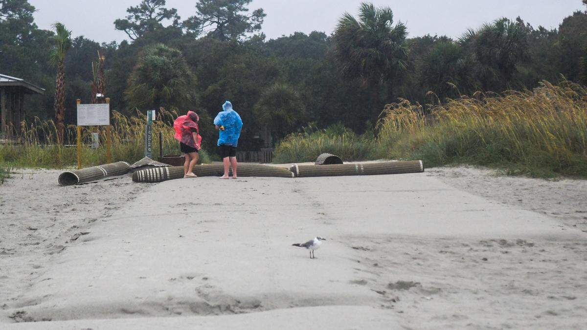 A couple tries to decide if they want to go to the beach to brave the winds and rain from Tropical Storm Debby on Aug. 5, 2024 on Hilton Head Island.