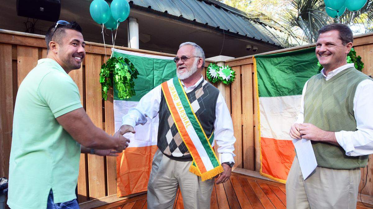 Former Hilton Head Island Mayor Tom Peeples was named grand marshal of the 29th annual Hilton Head St. Patrick's Parade during a ceremony Tuesday at The Board Room. Here, Peeples, center, shakes hands with Joe Roces, owner of Merchant Service Center, the parade's presenting sponsor. Looking on is parade committee member Alan Perry. The parade down Pope Avenue is scheduled for 3 p.m. Sunday, March 11.