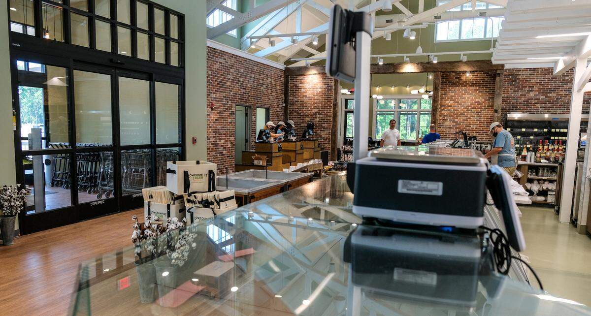 Shopping carts are ready for customers in the vestibule at Lowcountry Fresh Market and Cafe with check out clerks to the right of the door, center of photo, as customers leave. The market and cafe is located along Buckwalter Parkway in Bluffton.