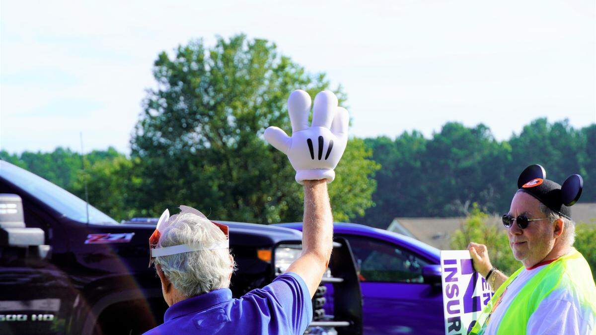 One Friday morning protester waved to passing cars with the iconic glove of Mickey Mouse. Demonstrators wore Disney gear in reference to Florida governor Ron DeSantis’ recent clash with Disney, his home state’s largest employer, over the company’s “woke” business practices.