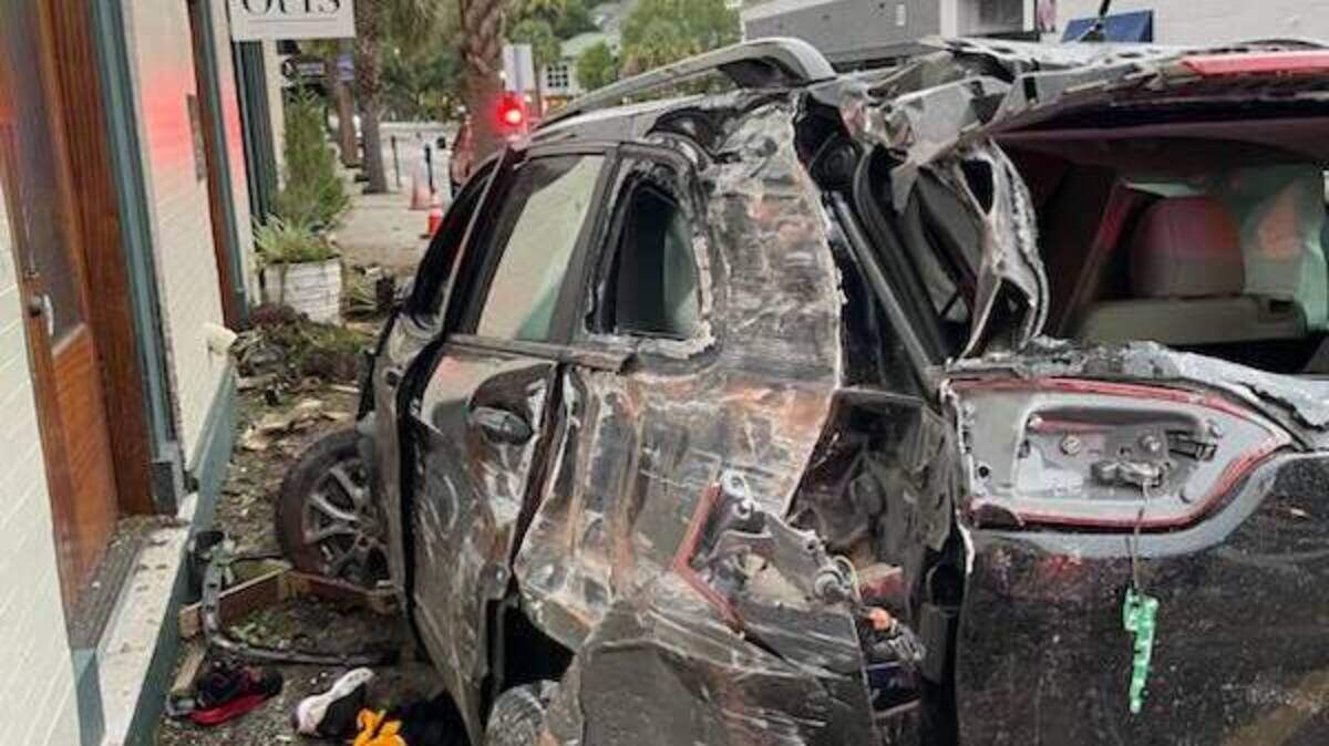 The car’s left side was badly damaged after its driver veered onto the Carteret Street sidewalk early Tuesday morning, swiping a storefront and downing two palm trees in the process.