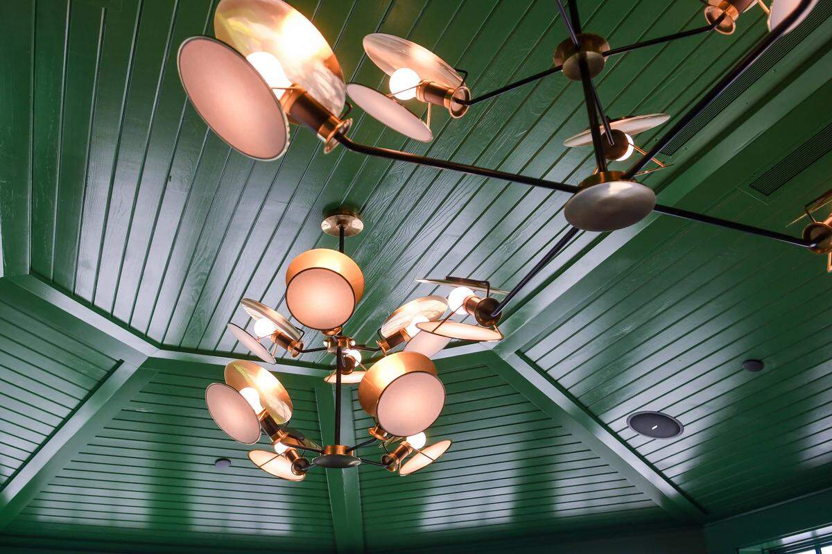 The multi-armed light fixtures are shown in the Quarterdeck restaurant’s “Green Room,” which can be reserved for intimate parties.