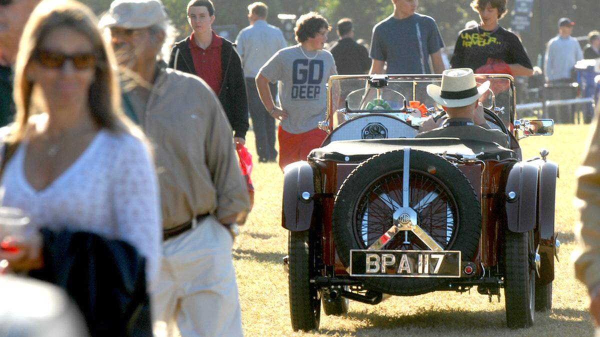 In this file photo, an entrant in the Hilton Head Island Motoring Festival and Concours d'Elegance motors his way through a crowd of people at Honey Horn on Hilton Head Island. The festival is moving this year from Honey Horn to Port Royal Golf Club.