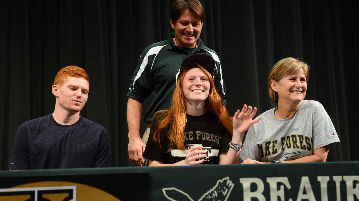 Jackie Barnes, center, smiles with her older brother Ben, father Ben and mother Mandy at her signing ceremony on Friday afternoon in the Beaufort High School Performing Arts Center in Beaufort.  Barnes has signed with Wake Forest University.