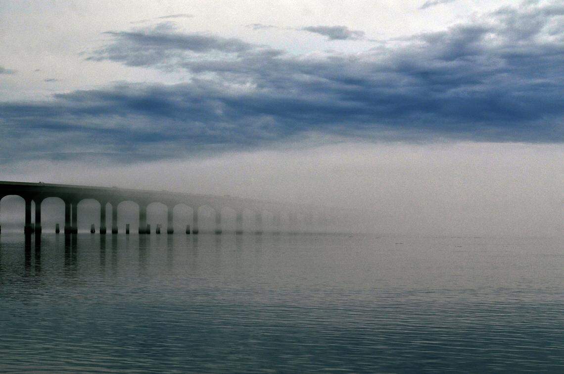 Fog is seen engulfing the Broad River Bridge looking towards Lemon Island from the Broad River Marina at dusk on  January 13, 2015.