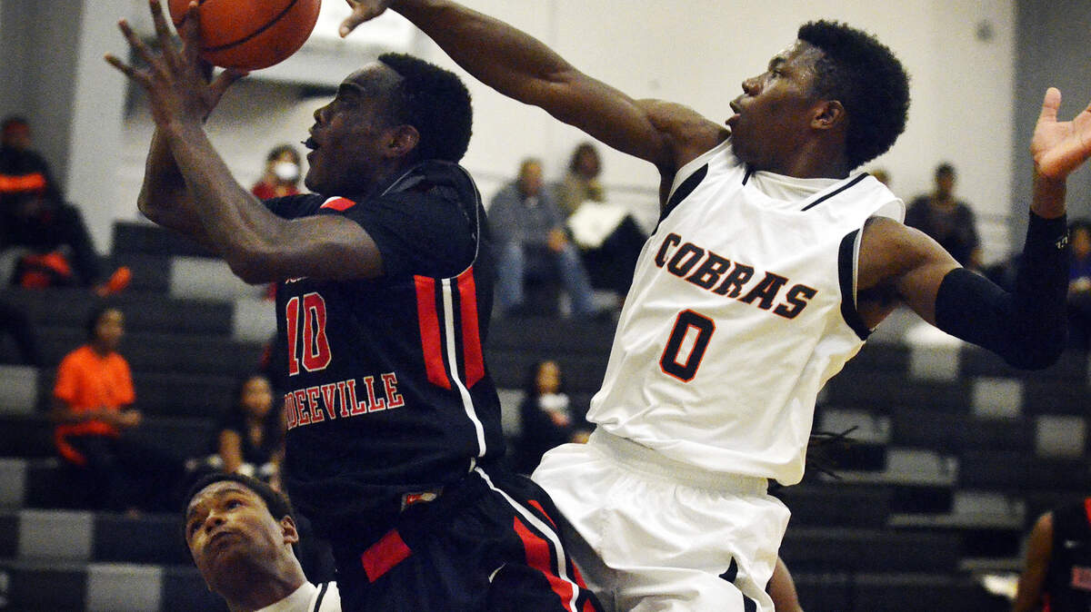 Boyd Anderson guard Danny Harris Jr., right, defends against Ridgeland-Hardeeville shooting guard Kevon Williams, as forward Justin Shaw, bottom left, is called for a block, during the ninth annual Bobcat Classic on Tuesday at Bluffton High.