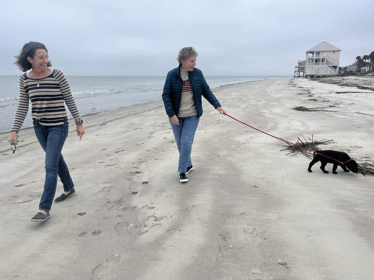 Lisa Morris walks her new pup Forrest George Morris on Harbor Island Jan. 7. On New Year’s Day, Morris and Tricia Gustin, left, were walking their dogs on the same beach when Emily, Morris’ 2 1/2-year-old black lab, swallowed a large fish hook and later died. The tragedy has galvanized Harbor Island residents to raise awareness about hooks and trash left behind on area beaches. “I want to make people aware they need to pick up their stuff,” Morris says.