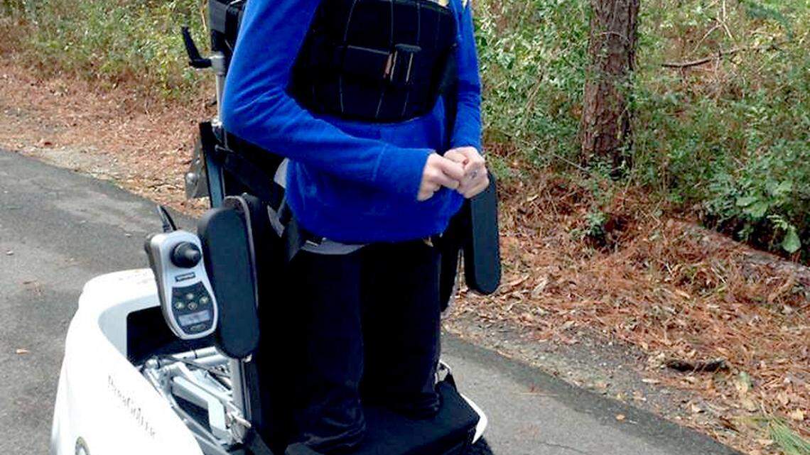 Kelli Bright is pictured using a Paramobile wheelchair. The device allows her to move in a standing position. 
