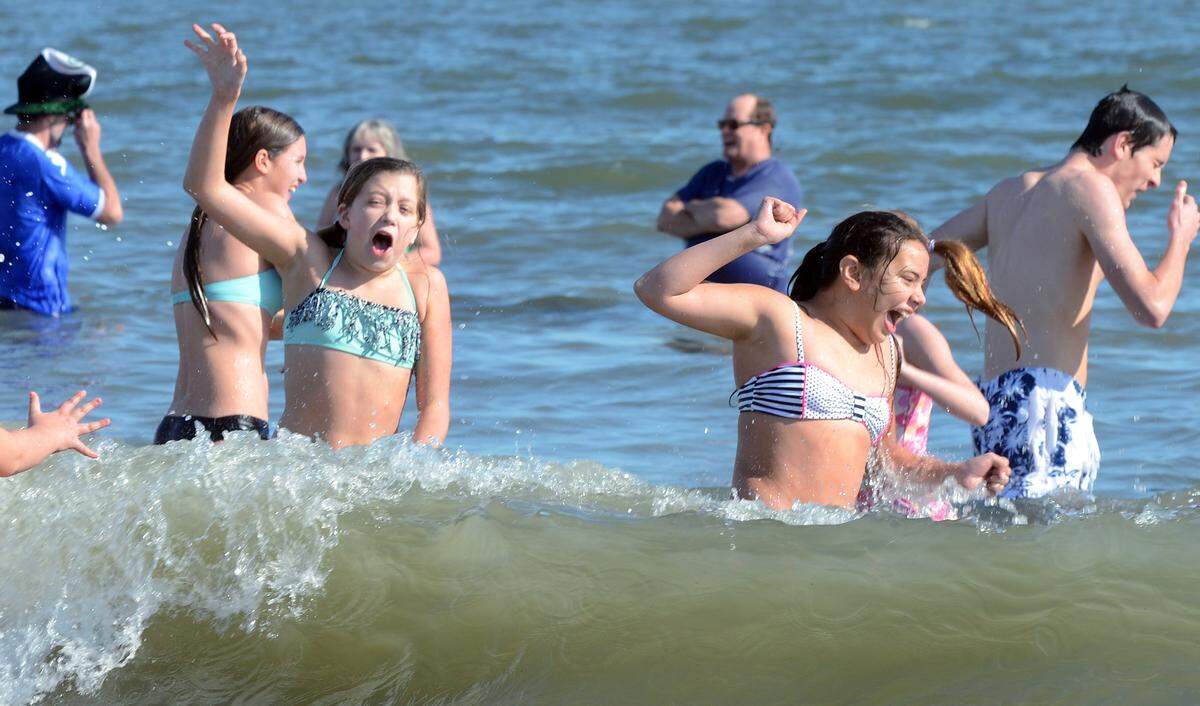Pelican Plunge participants react to getting splashed by a cold wave of ocean water during the New Years Day event on Thursday at Hunting Island State Park. Hundreds of hearty souls braved the cold water to participate in the seventh annual event, sponsored by the Friends of Hunting Island to benefit the park's Discover Carolina education program.