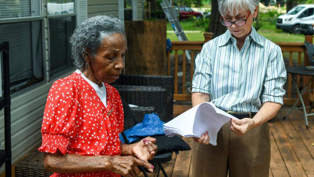 Josephine Wright starts to count her relatives, including her son, that are buried in Elliott Cemetery, a Gullah graveyard located behind the gates in Hilton Head Plantation on June 9, 2023 as Kelly LeBlanc looks over a list on Hilton Head Island. Wright is currently fighting to keep her land that family says has been in their name around the end of the Civil War.